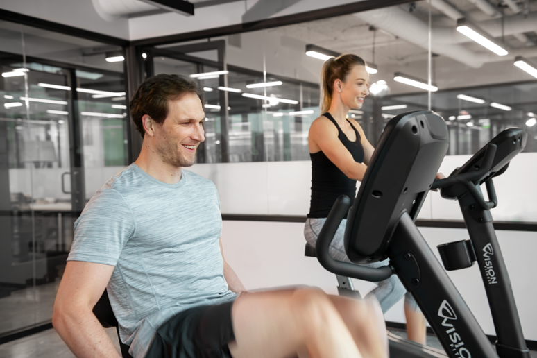 VF LIFESTYLE LC male female smiling looking forward working out R60 U60 angle front lores